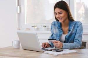 Girl making a payment online with a credit card