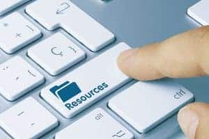 Closeup view of a hand pressing the resource button on a laptop